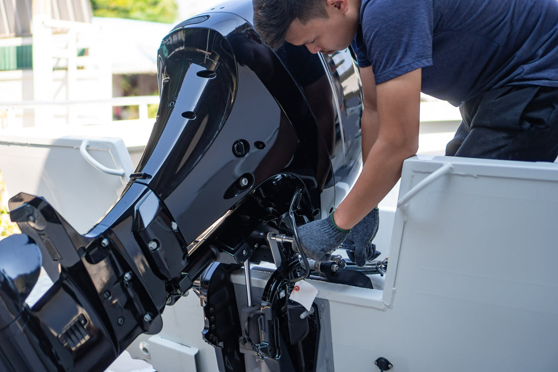 Marine technician working on a boat engine in a marina service bay